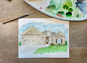 Watercolor painting of home with brush and Pallett